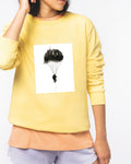 The Art of Freefall - Wearable skydiving art on a yellow sweatshirt