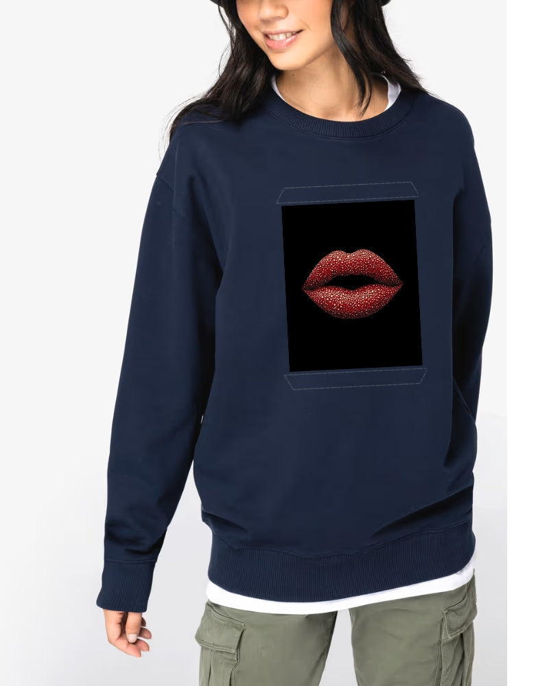 Woman wearing a sweatshirt featuring an artwork of red lips embellished with crystals